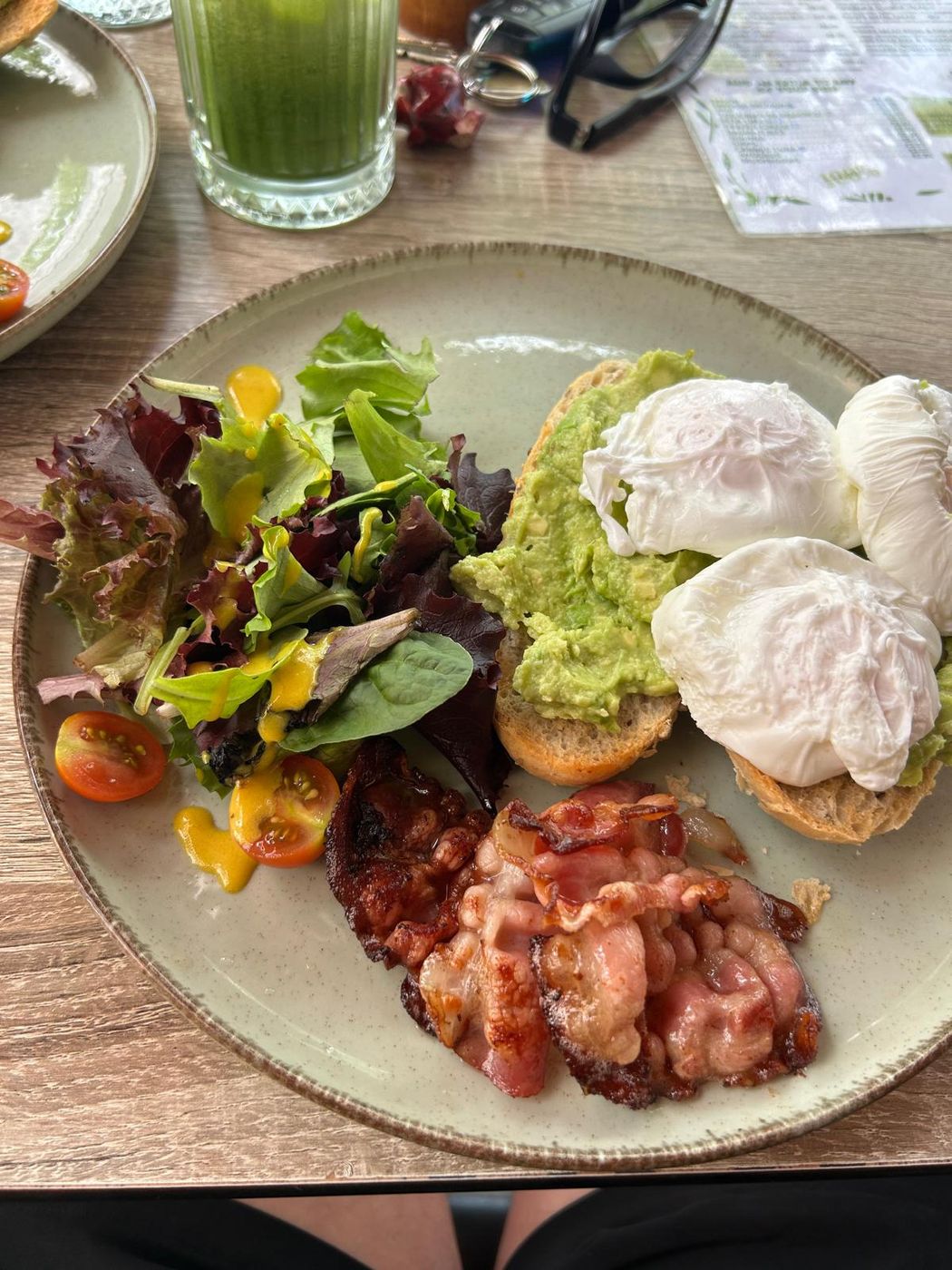 Avocado toast with eggs, bacon and salad