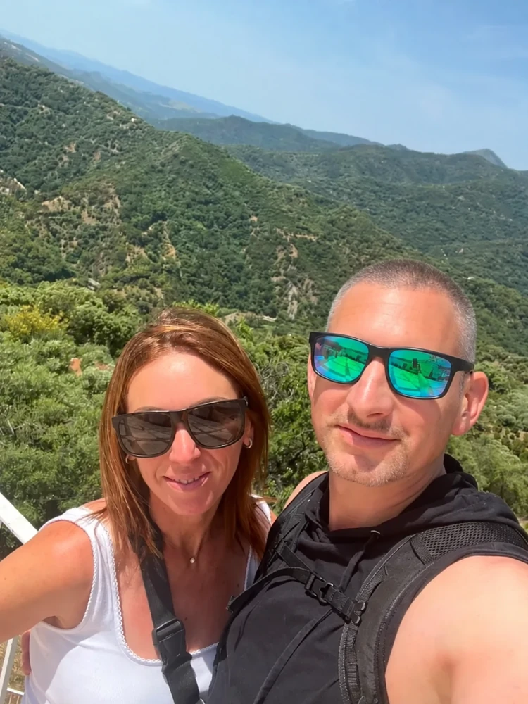Mark and Keely smiling on a sunny mountain walk